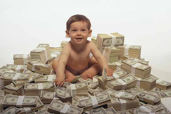 Baby sitting on pile of money